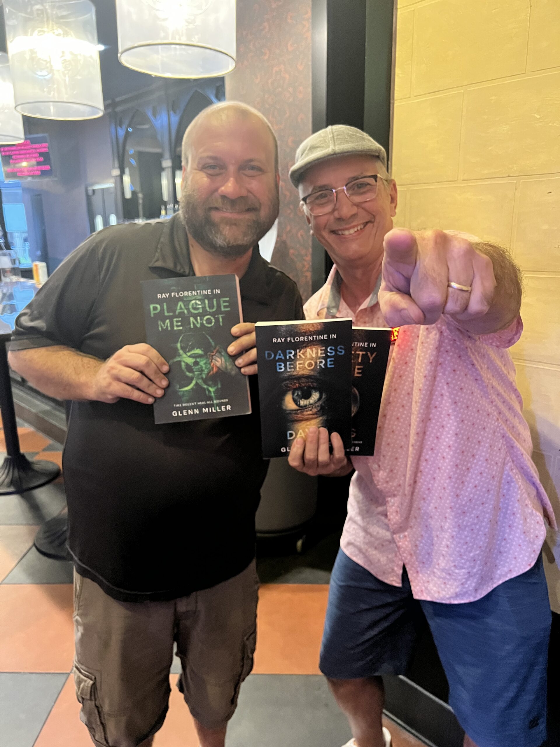 Readers holding Glenn Miller books at an event